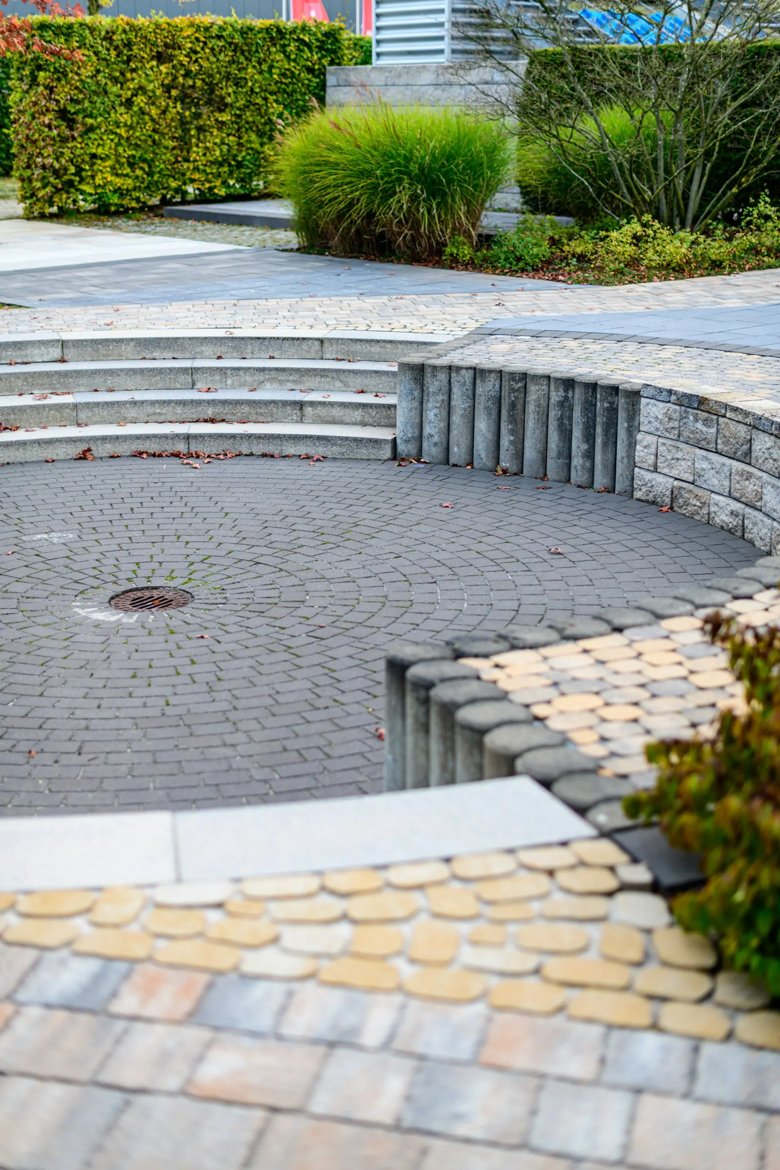 Curved paver walkway adjacent to a clean patio seating area, post-wash.