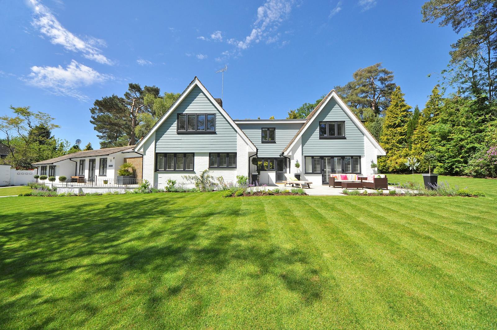 White-painted house with clean Hardie-style siding and bright trim after a soft-wash.